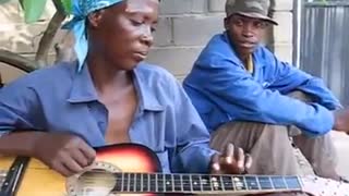 African old lady playing the guitar!!!
