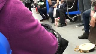 Violin and drums played by two people on train