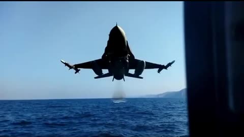 Turkish Air Force F-16 fighter jet passing at extremely low altitude over the sea.