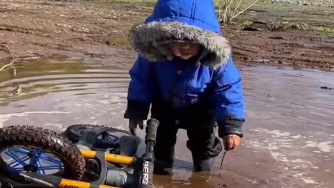 Son Plays In The Mud