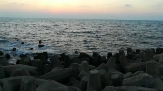 Old Beach Rocks With Water Waves In Sunset Ras El Bar