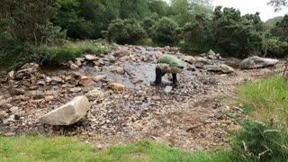 Washing my cup in a river