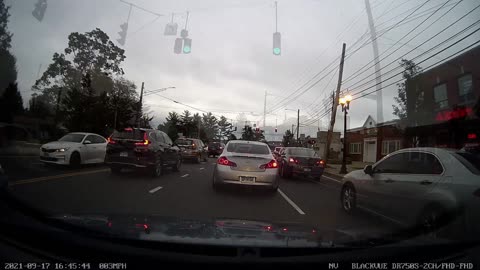 Guy runs red light and then gets stuck in traffic