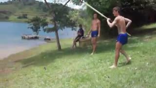 Guy tries to pole vault into lake but fails and flops into water