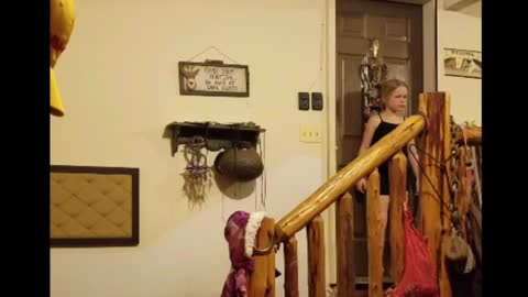 Little girl in black scared by person dressed as rabbit