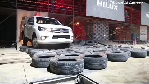 Pickup trucks are displayed over tires