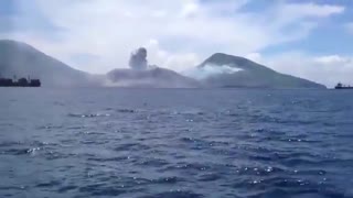 Volcano erupts and blows the clouds away