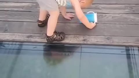 Toddler tries to walk on glass