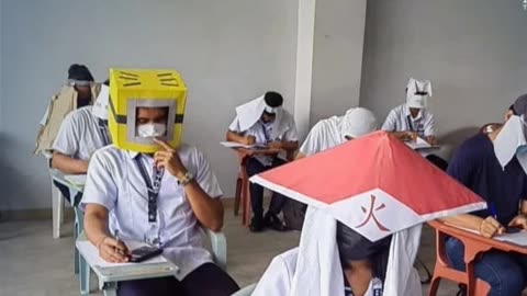 Bangkok University Students Wear Anti-Cheating Helmets During Midterms