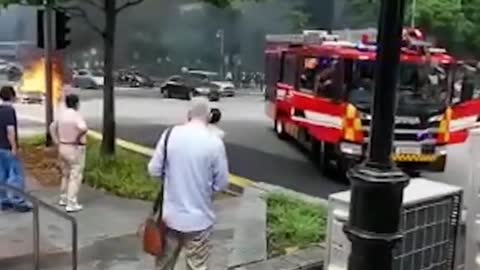 Burning Mercedes seen at junction outside Lau Pa Sat