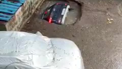 Car sinks in an old unused well due to heavy rain