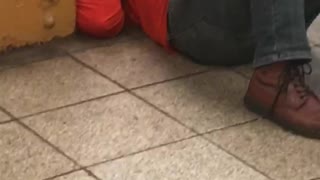 Woman red shirt laying on subway floor