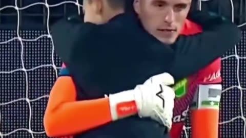 Little boy runs onto the pitch to comfort the goalkeeper who just lost the match