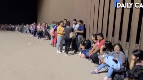 Migrants Line Up As Far As The Eye Can See Along The Arizona Border