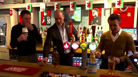 Britain's Prince William pulls pints in a Welsh pub