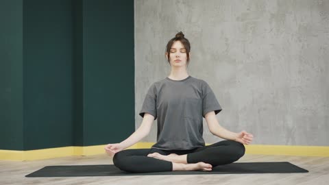 A Woman Meditating In Lotus Position