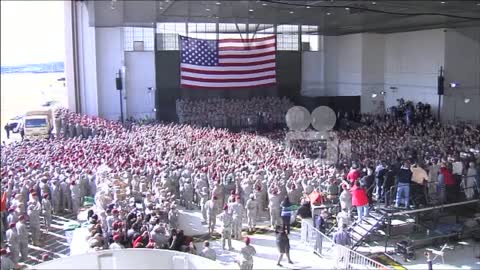 A Huge Crowd Of American Soldiers Waits To Greet President And Michelle Obama Inside A Military