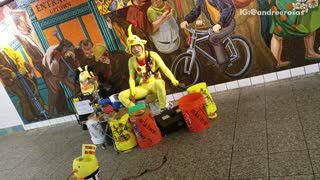 Man yellow chicken outfit playing drums