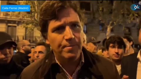 Tucker Carlson gives interview in middle of a Protest in Madrid, Spain