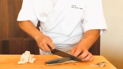 Cutting fresh mackerel sashimi.