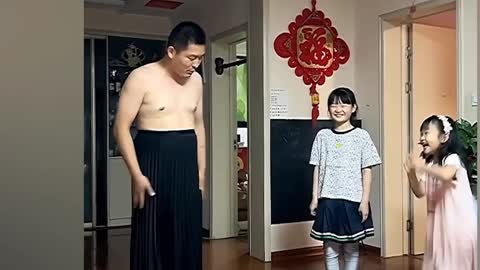 Chinese father puts on dress to show daughters proper way to behave