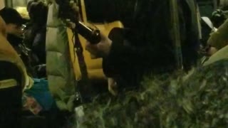 Guy sings and plays his guitar on subway