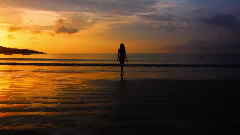A Woman Walking Towards The Sea