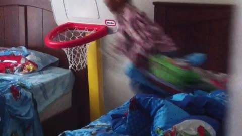 Little kid tries to jump from blue bed to blue bed but hits chin