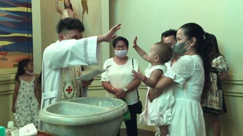 Baby High-fives Priest During Her Own Baptism