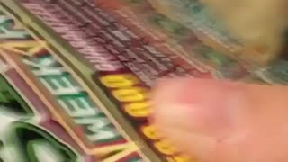Woman scratches her lottery ticket with a piece of tortilla