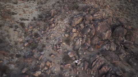 People Climbing Rocky Desert Mountain