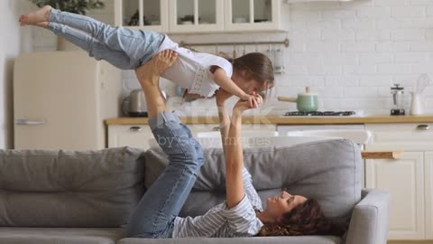 Happy attractive young mother lifting overjoyed little daughter. stock video