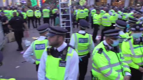 Extinction Rebellion Police bring down protester in a cherry picker.