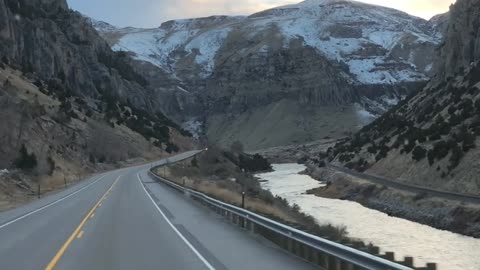 Travel Views - Driving Between Hills and River