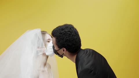 Newly Wed Couple Kissing While Wearing Masks