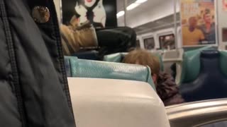 Woman sits upside down feet in the air on subway train