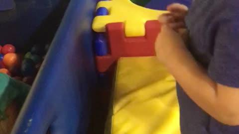 Little kid dives face first into ball pit