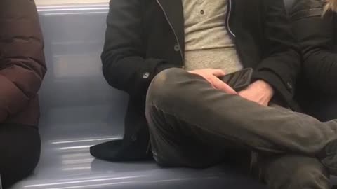 Sleeping man on subway train wakes up from baby crying