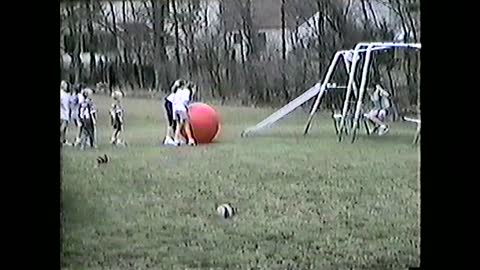 Swinging Girl Kicks Giant Red Ball That Hits Boy In The Face