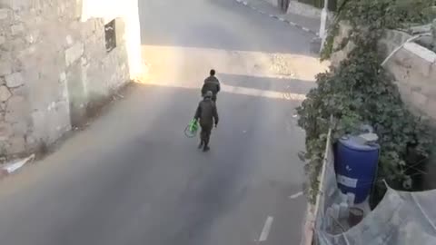 Israeli occupation soldiers confiscate a Palestinian child's bicycle and throw it into a dumpster