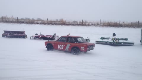 Serviceman Playing With Old Datsun Race Car In Snow