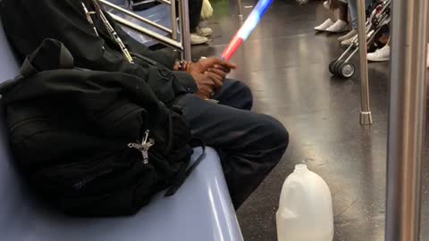 Man plays with red white and blue glow stick