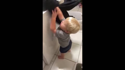 Toddler loves to help mommy with the laundry