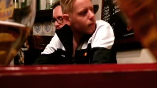 Music drunk guy in black shirt singing in restaurant