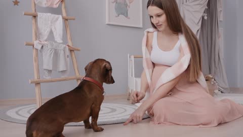 Pregnant Woman Training a Dog