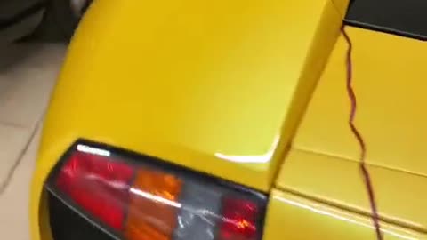 Look at the configuration of a yellow sports car.