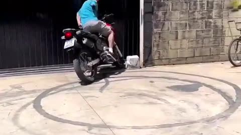 one armed man attempts a donut on a motorbike