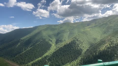 Blue sky, white clouds and mountains