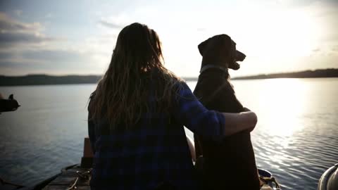 Woman and dog at end of dock camping