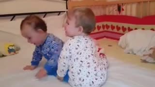 Twins engage in adorable battle for tablet